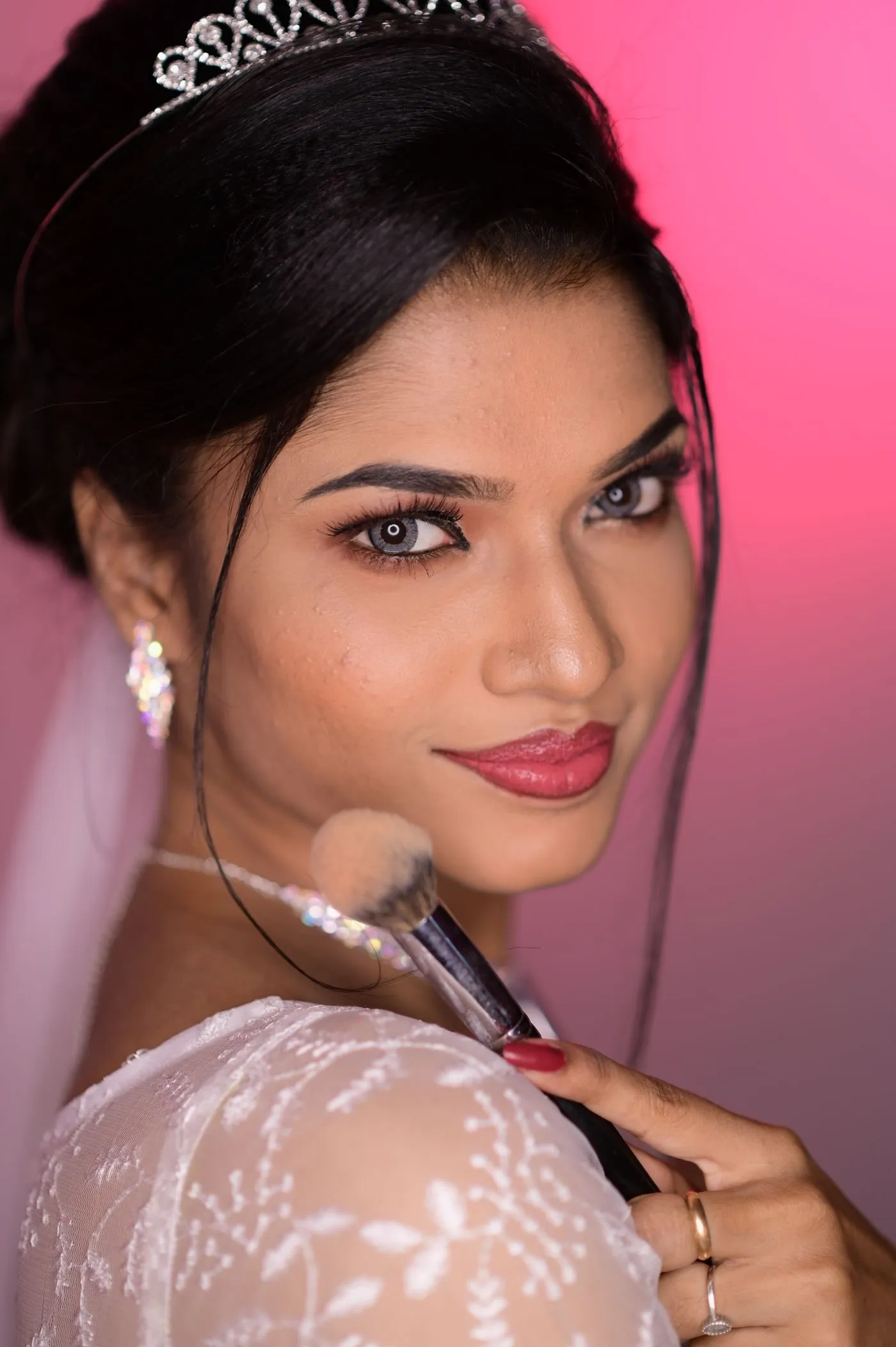 Woman with polished, natural makeup holding a powder brush